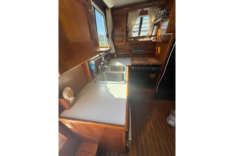 Slide: The Image of 2001 Monk Trawler kitchen interior with wooden cabinetry and dual sink. - 43