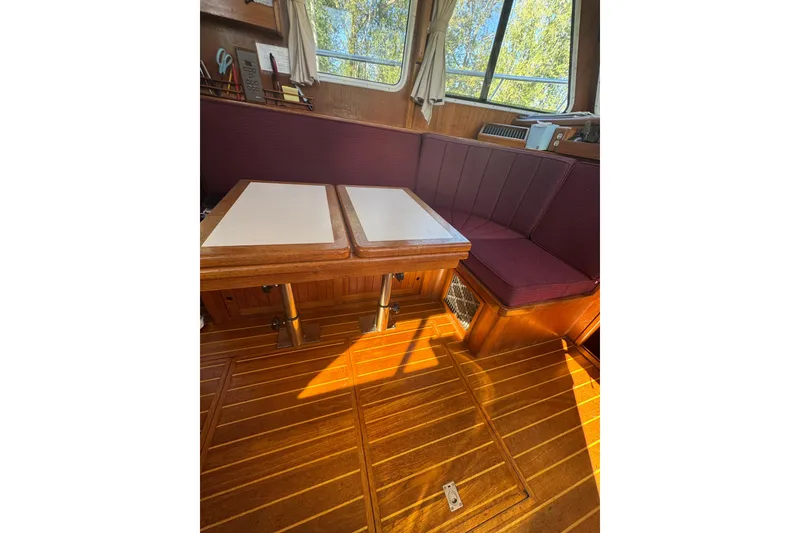 Slide: The Image of Interior of 2001 Monk Trawler with wooden flooring and maroon seating. - 44