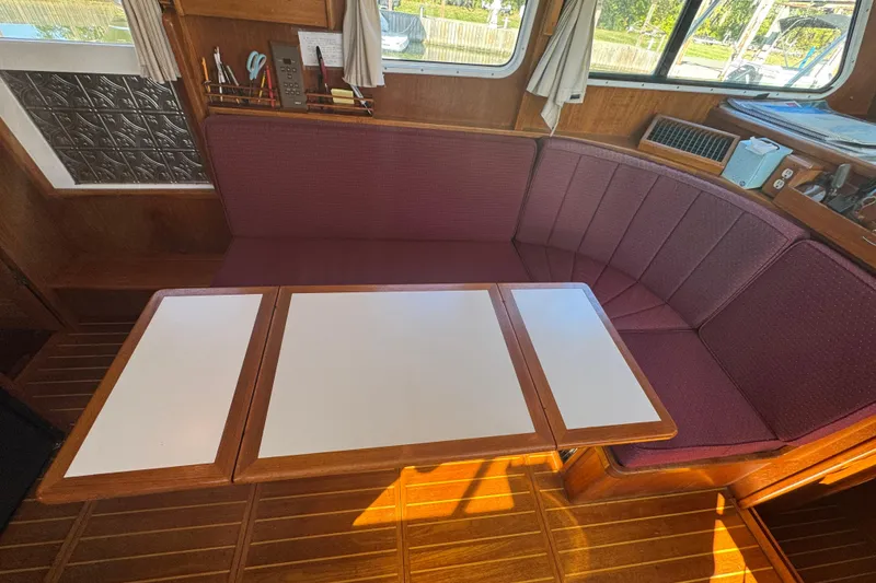 Slide: The Image of Interior of 2001 Monk Trawler with wooden table and maroon seating. - 45