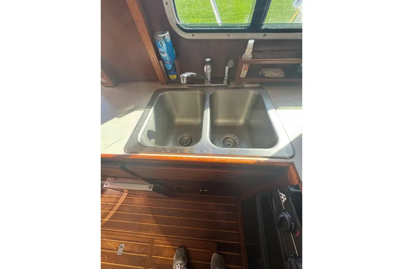 Slide: The Image of 2001 Monk Trawler kitchen sink with dual basins and wooden flooring. - 47