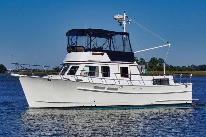 Slide: The Image of 2001 Monk Trawler boat on calm water with blue sky background. - 5