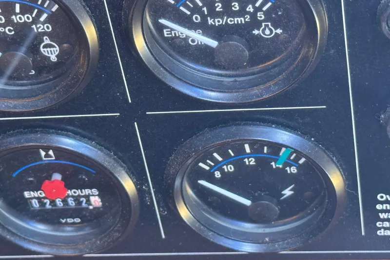 Slide: The Image of Close-up of 2001 Monk Trawler dashboard gauges displaying engine metrics. - 59