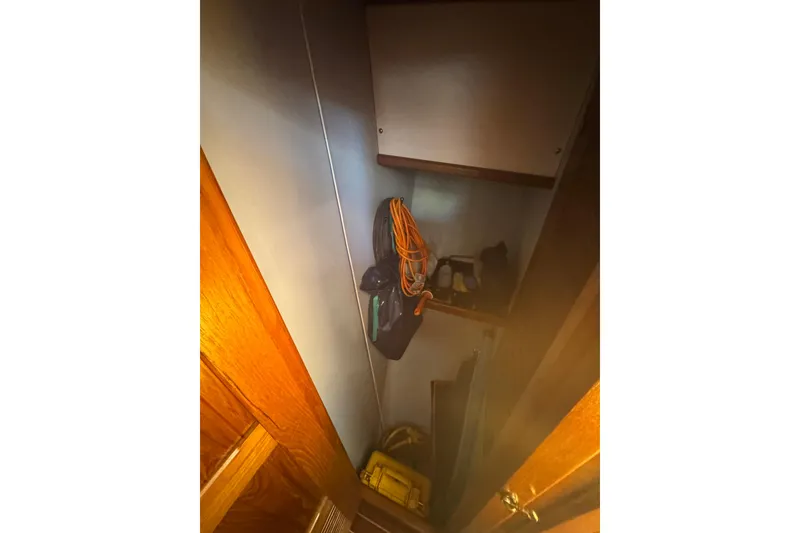 Slide: The Image of Storage area inside a 2001 Monk Trawler boat with shelves and equipment. - 60