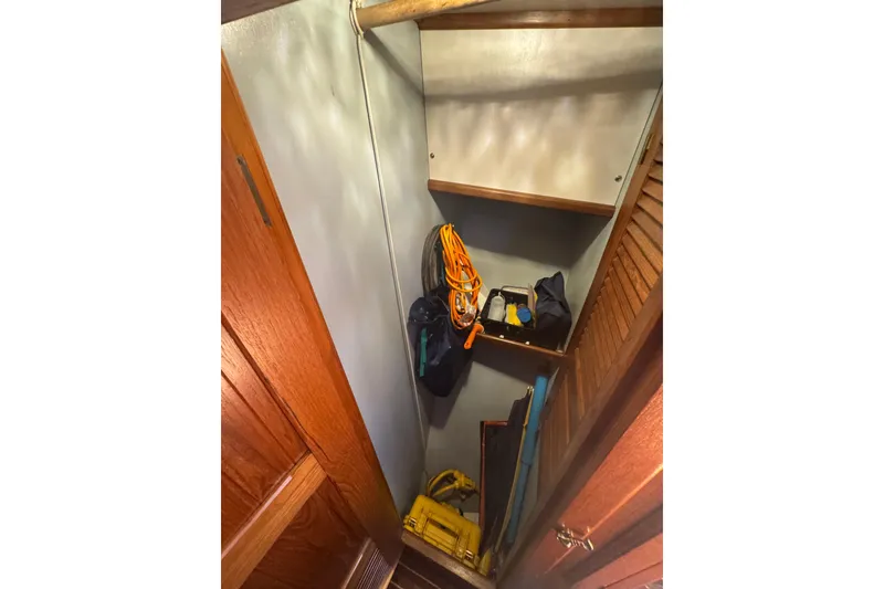 Slide: The Image of Storage closet on 2001 Monk Trawler with shelves and various equipment. - 61