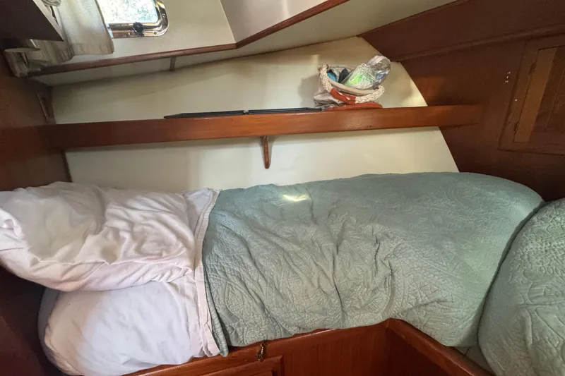Slide: The Image of Cozy cabin interior of 2001 Monk Trawler with bed and shelf. - 69