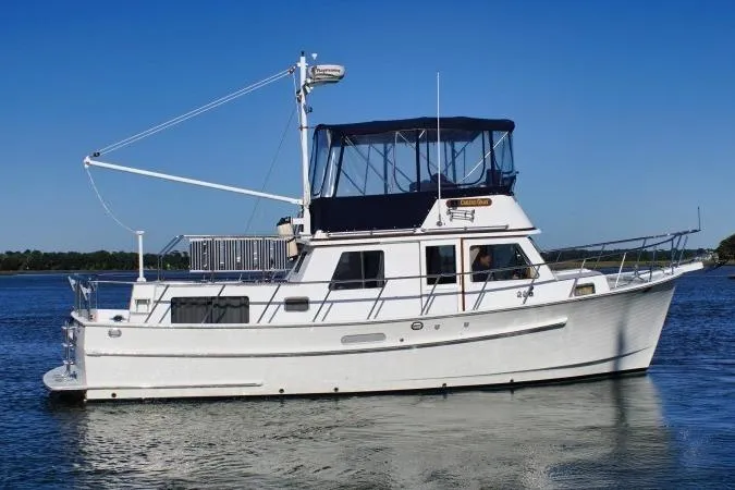 Slide: The Image of 2001 Monk Trawler boat on calm water under clear blue sky. - 7