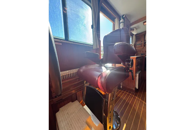 Slide: The Image of Captain's chair in 2001 Monk Trawler boat interior, with sunlight streaming through window. - 75