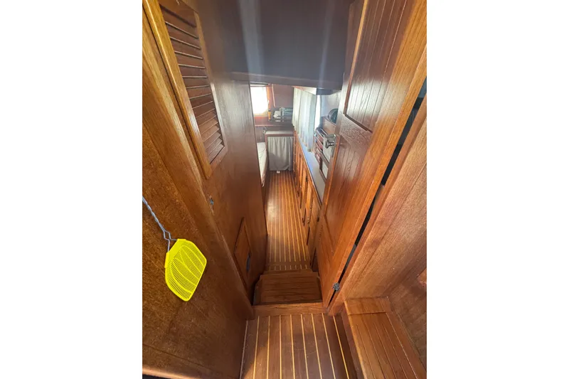 Slide: The Image of Interior of 2001 Monk Trawler with wooden paneling and narrow passageway. - 77
