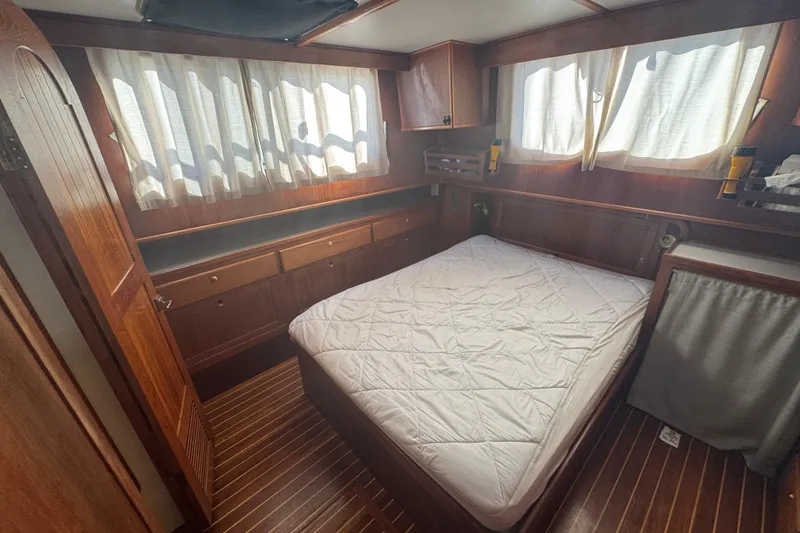 Slide: The Image of Cozy cabin interior of 2001 Monk Trawler with wood paneling and bed. - 81