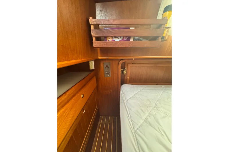 Slide: The Image of Interior of 2001 Monk Trawler with wooden cabinetry and bed, showcasing cozy design. - 86