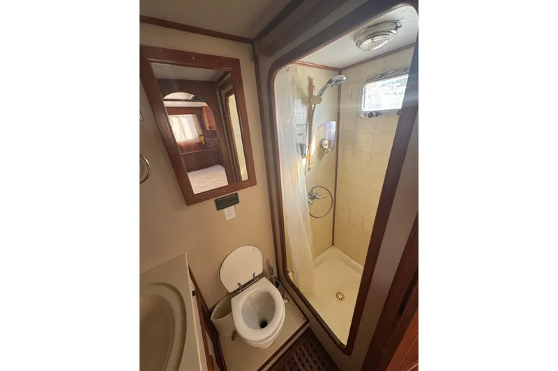 Slide: The Image of Bathroom interior of 2001 Monk Trawler with shower, toilet, and mirror. - 90