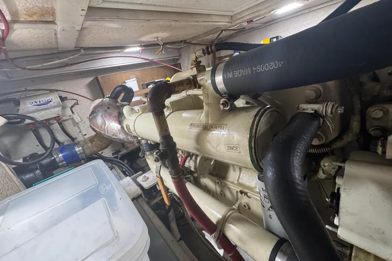 Slide: The Image of Engine room of a 2001 Monk Trawler showcasing mechanical components and hoses. - 95