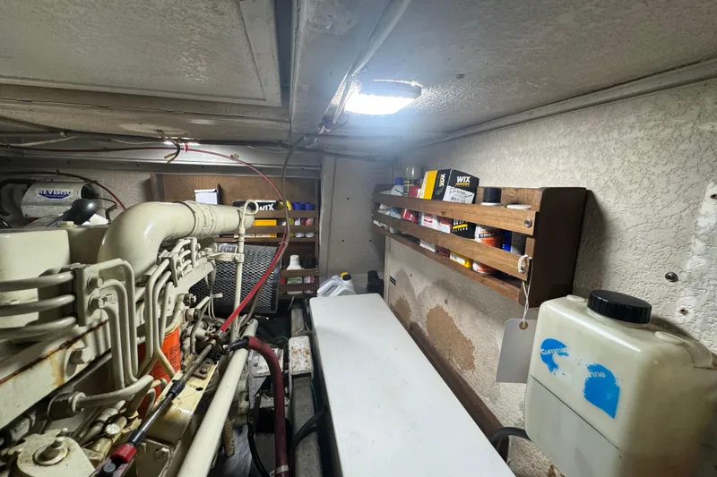 Slide: The Image of Engine room of a 2001 Monk Trawler with organized shelves and maintenance supplies. - 97