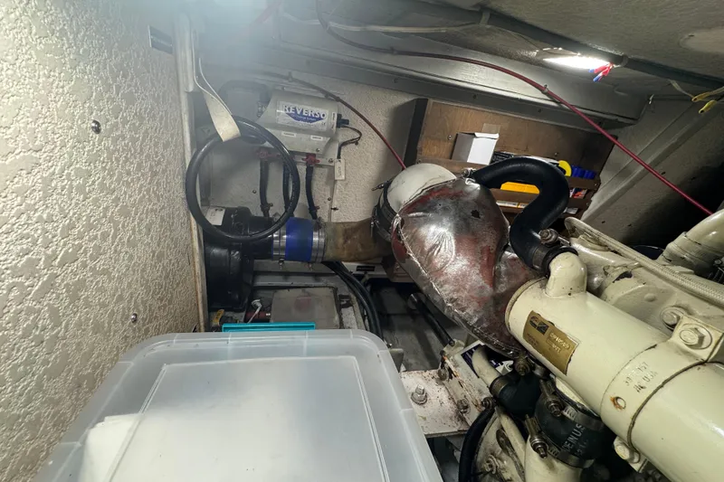 Slide: The Image of Engine room of a 2001 Monk Trawler with visible mechanical components and wiring. - 98