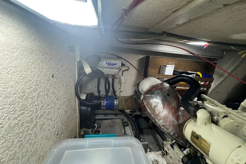 Slide: The Image of Engine room of a 2001 Monk Trawler, featuring mechanical components and storage. - 99