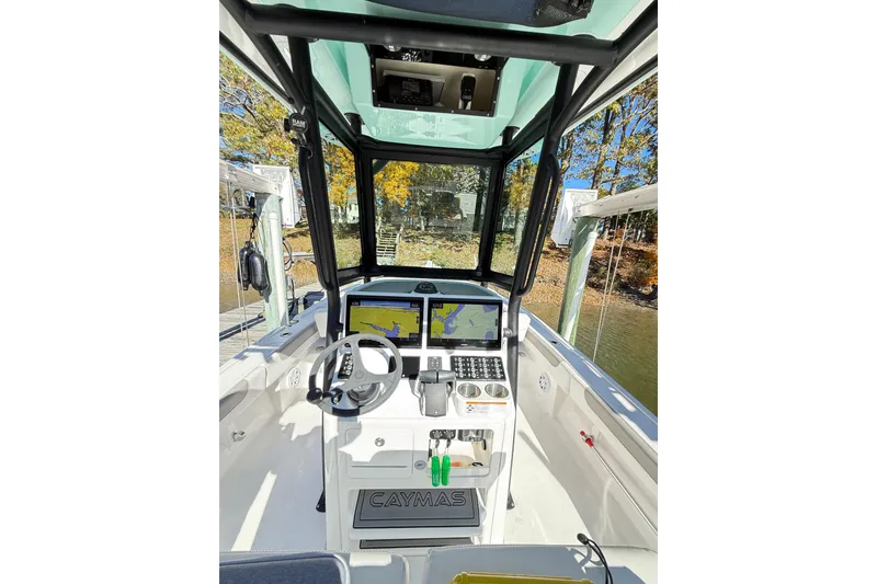 Slide: The Image of 2023 Caymas 281 HB boat cockpit with advanced navigation system and steering wheel. - 12