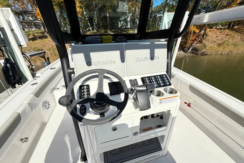 Slide: The Image of 2023 Caymas 281 HB boat dashboard with Garmin navigation system and steering wheel. - 14