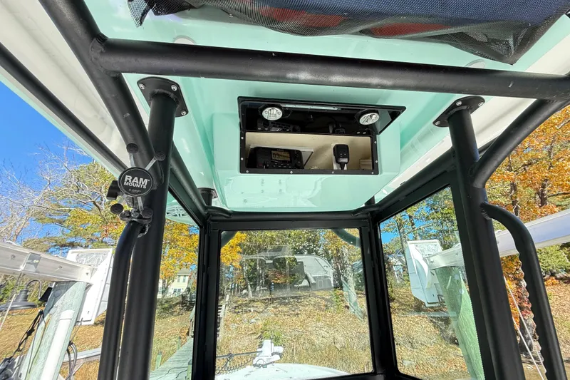 Slide: The Image of Interior view of 2023 Caymas 281 HB boat with mounted equipment and clear windows. - 15