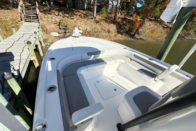 Slide: The Image of 2023 Caymas 281 HB boat docked, featuring spacious seating and modern design. - 25