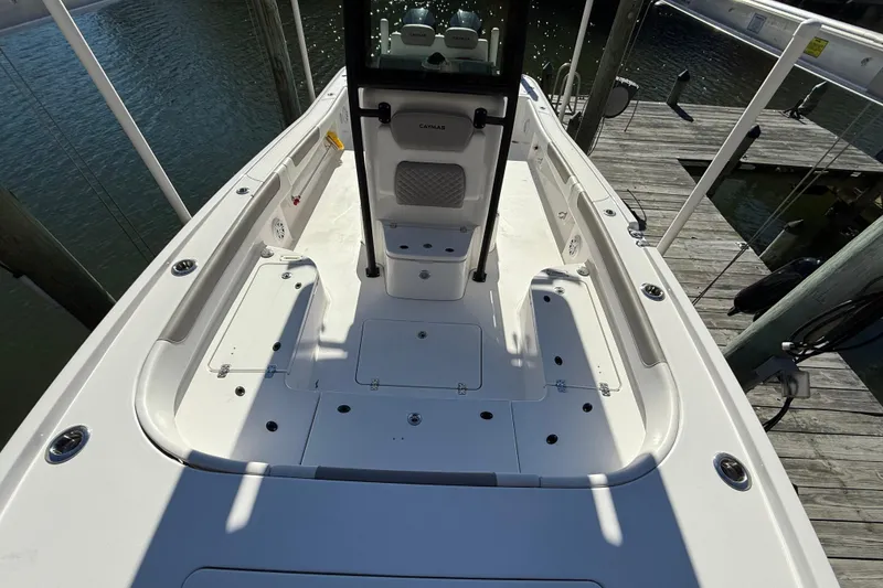 Slide: The Image of 2023 Caymas 281 HB boat deck view, docked by the water. - 28