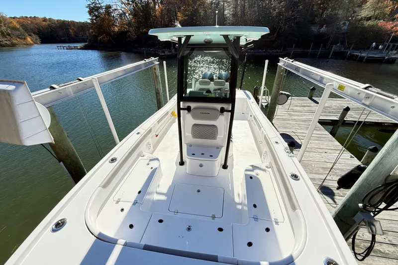 Slide: The Image of 2023 Caymas 281 HB boat docked on a scenic lake with autumn foliage. - 29