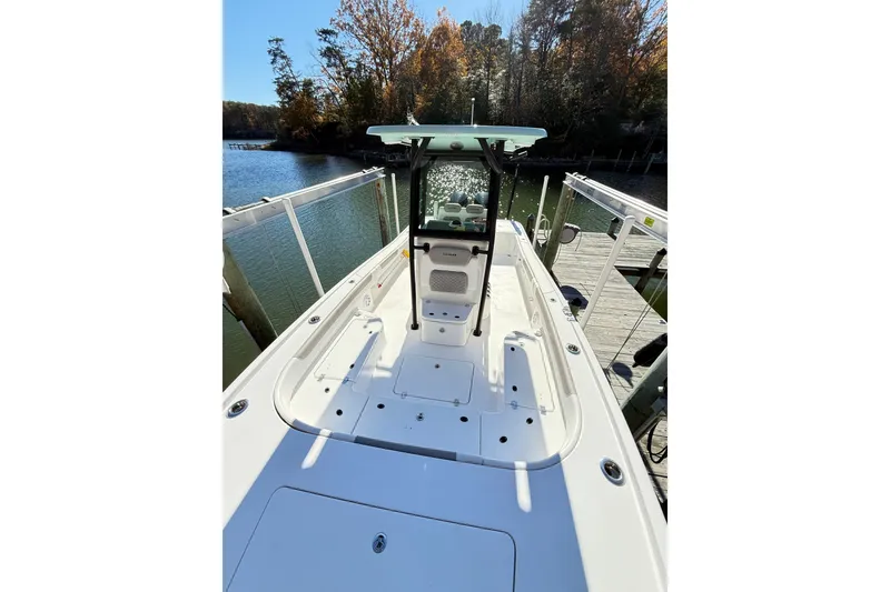 Slide: The Image of 2023 Caymas 281 HB boat docked by a scenic waterfront with autumn trees. - 30