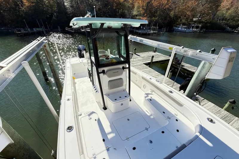 Slide: The Image of 2023 Caymas 281 HB boat docked on a sunny waterfront with sparkling water. - 32