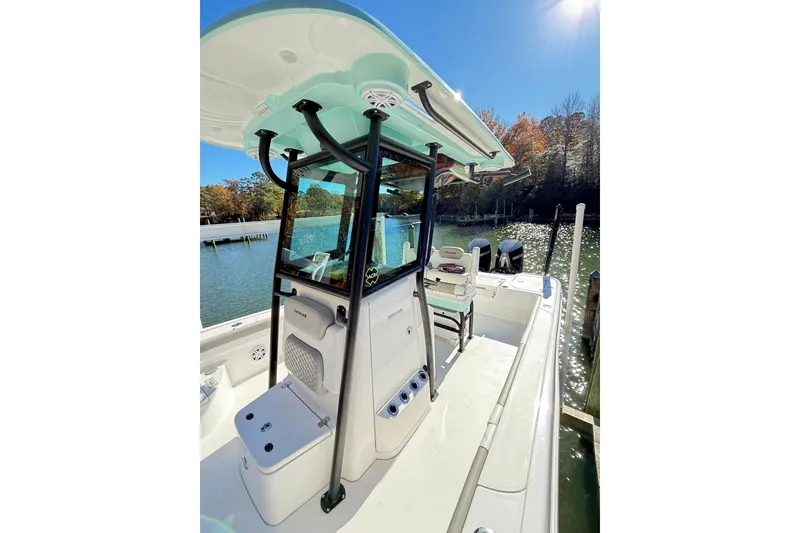 Slide: The Image of 2023 Caymas 281 HB boat docked on a sunny day, showcasing sleek design and spacious deck. - 34