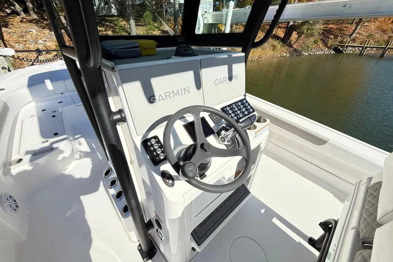 Slide: The Image of 2023 Caymas 281 HB boat cockpit with Garmin navigation system and steering wheel. - 35