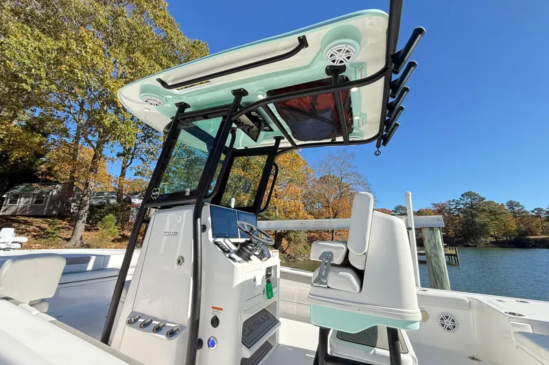 Slide: The Image of 2023 Caymas 281 HB boat with advanced console and seating, set against a scenic lake backdrop. - 41