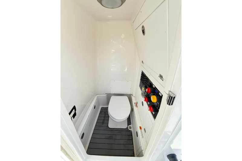 Slide: The Image of 2023 Caymas 281 HB boat interior with compact marine toilet and control panel. - 46