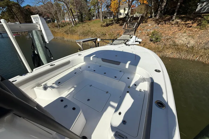 Slide: The Image of 2023 Caymas 281 HB boat docked by a wooded shoreline in autumn. - 48