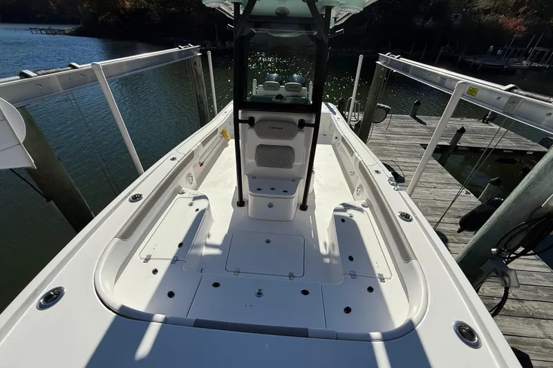 Slide: The Image of 2023 Caymas 281 HB boat docked, showcasing spacious deck and sleek design. - 49