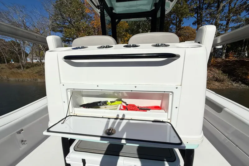 Slide: The Image of 2023 Caymas 281 HB boat with open storage compartment and fishing gear. - 50