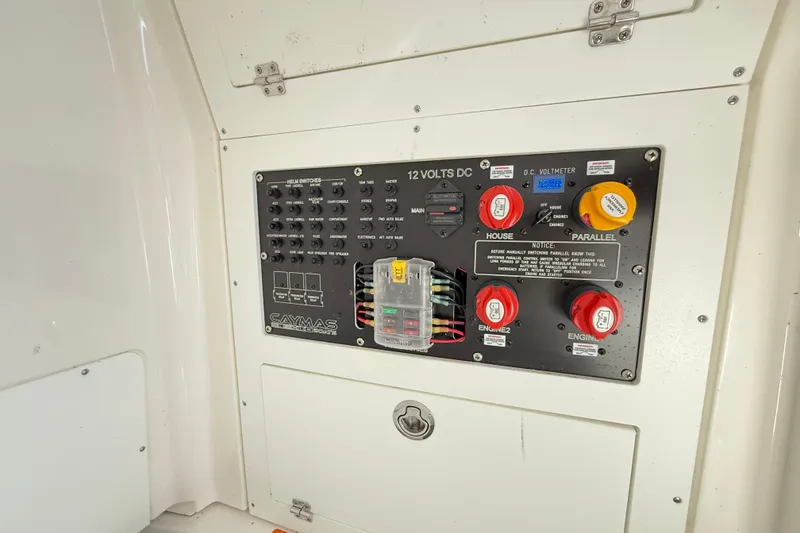 Slide: The Image of Control panel of 2023 Caymas 281 HB boat with switches and voltmeter. - 55
