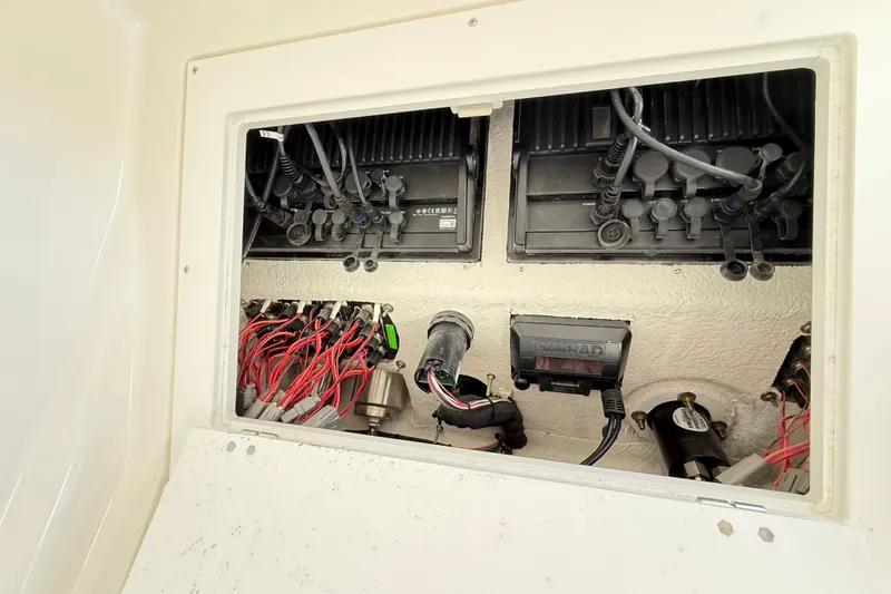 Slide: The Image of Electrical wiring and components inside a 2023 Caymas 281 HB boat. - 56