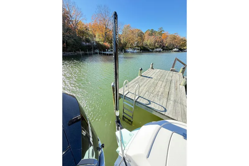 Slide: The Image of 2023 Caymas 281 HB boat docked by a wooden pier on a sunny day. - 60