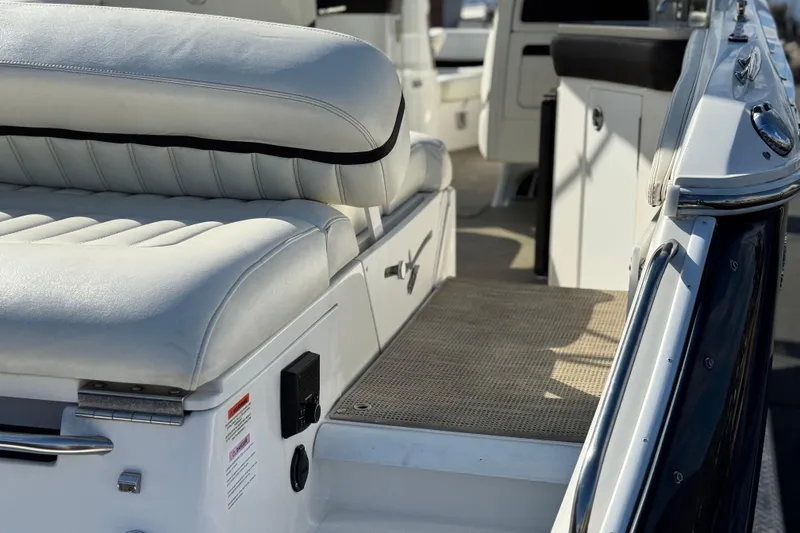 Slide: The Image of 2014 Cobalt 24SD boat interior with white seating and sleek design. - 10