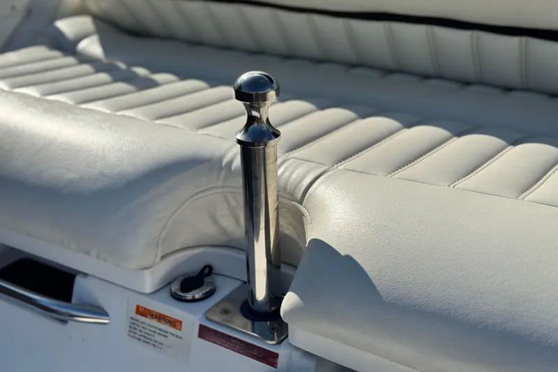 Slide: The Image of 2014 Cobalt 24SD boat interior with white leather seating and chrome details. - 11