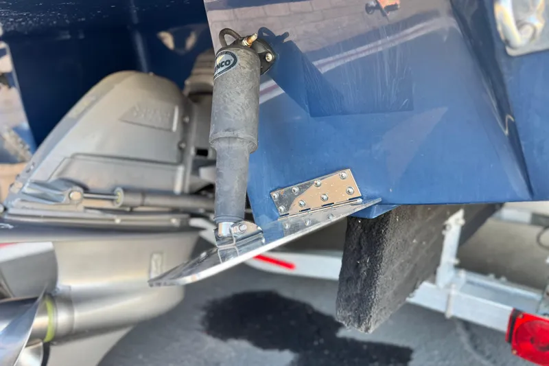 Slide: The Image of 2014 Cobalt 24SD boat stern with trim tab and hydraulic actuator. - 12