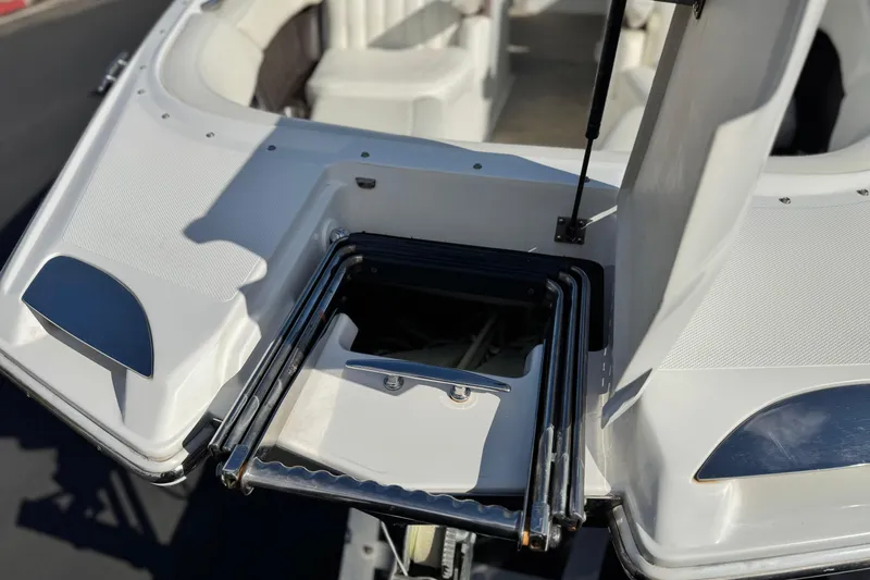 Slide: The Image of 2014 Cobalt 24SD boat with foldable swim ladder on deck. - 14