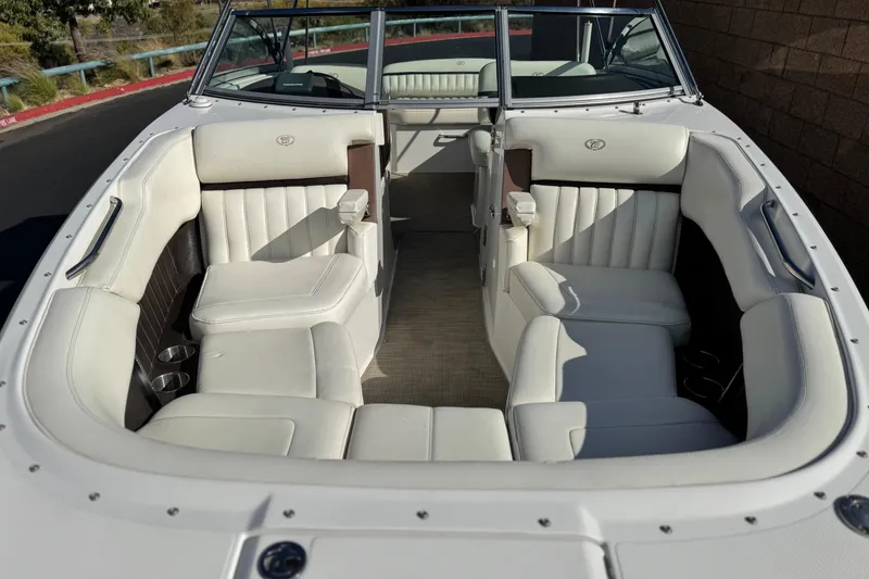 Slide: The Image of 2014 Cobalt 24SD boat interior with white leather seating and open bow design. - 15