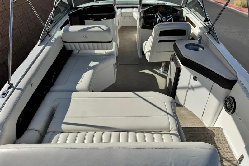 Slide: The Image of 2014 Cobalt 24SD boat interior with white seating and helm. - 16