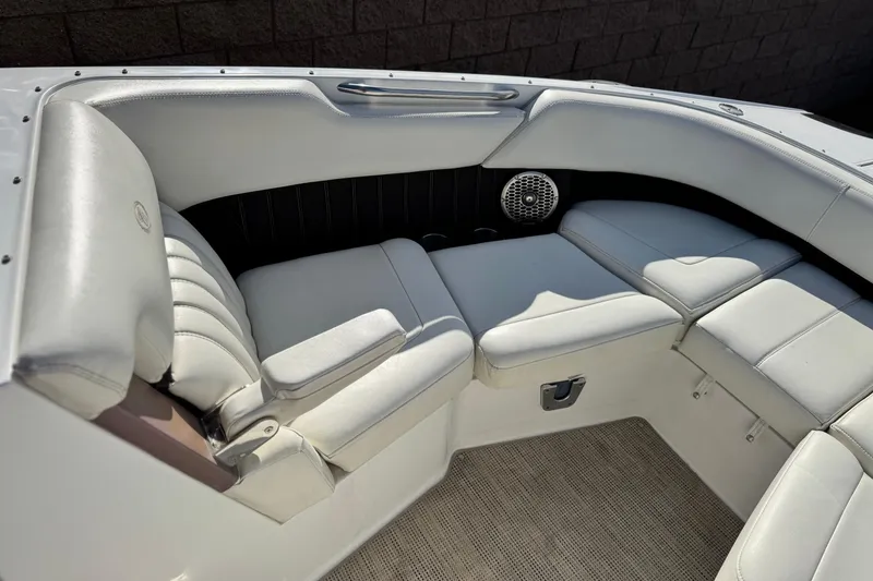 Slide: The Image of 2014 Cobalt 24SD boat interior with white leather seating and speaker. - 18