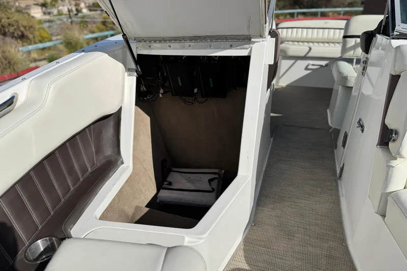 Slide: The Image of 2014 Cobalt 24SD boat interior storage compartment with open hatch. - 20