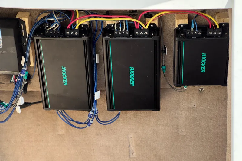 Slide: The Image of Audio amplifiers installed in a 2014 Cobalt 24SD boat, featuring Kicker brand equipment. - 21