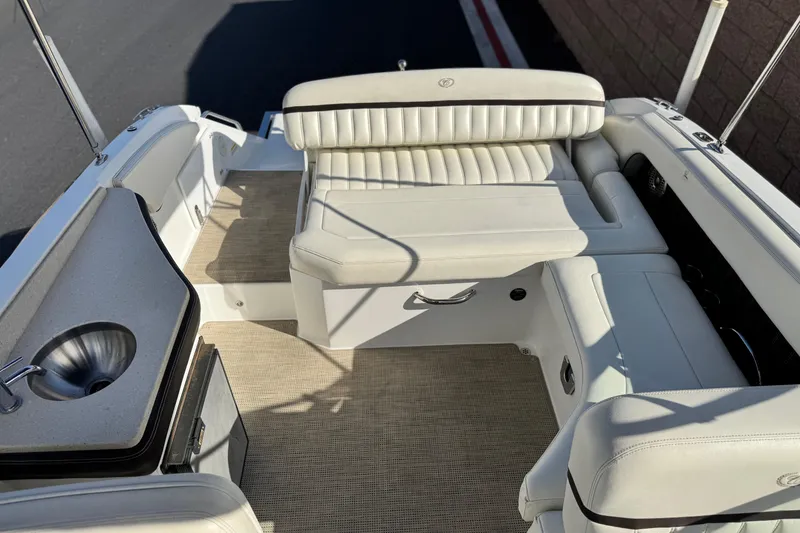 Slide: The Image of 2014 Cobalt 24SD boat interior with white seating and built-in sink. - 23