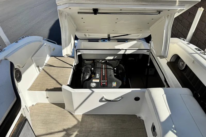 Slide: The Image of 2014 Cobalt 24SD boat engine compartment with open hatch, revealing engine details. - 24