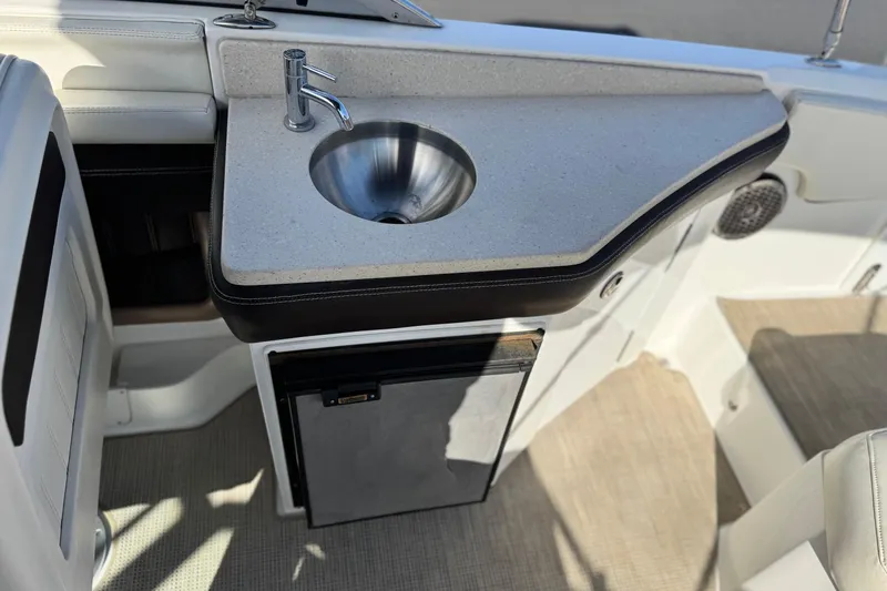 Slide: The Image of 2014 Cobalt 24SD boat interior with sink and mini fridge. - 26