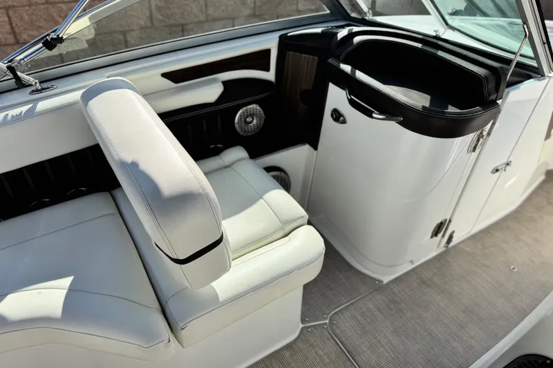 Slide: The Image of 2014 Cobalt 24SD boat interior with white seating and dashboard. - 30